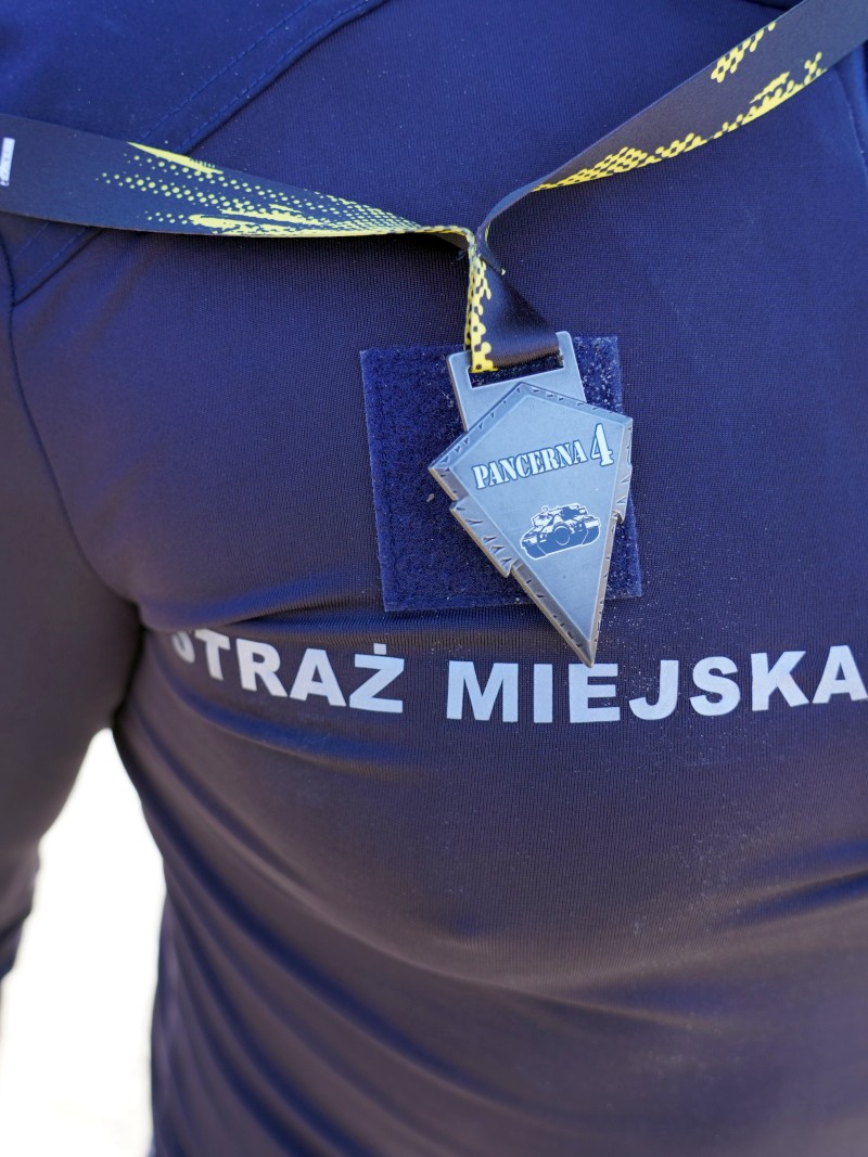 Medal ukończenia biegu na piersi strażniczki miejskiej.